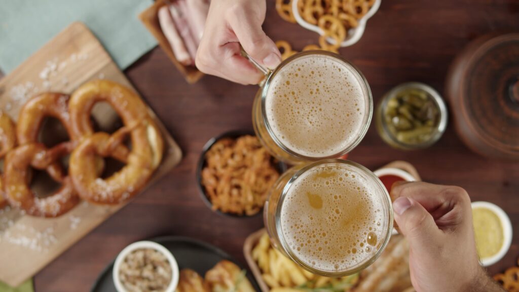 Traditional,German,Cuisine.,Putting,Frothy,Beer,In,Glasses,On,Table,